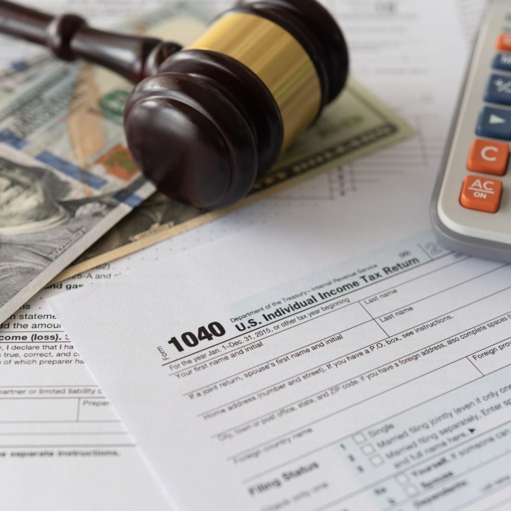 Tax forms with money, calculator and gavel